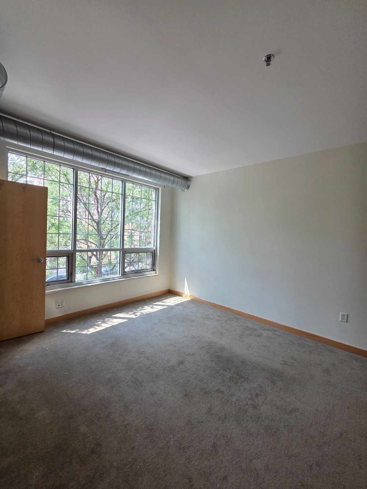 Finished room after full wall preparation and repainting, showing clean, even walls and sharp lines at the ceiling and trim