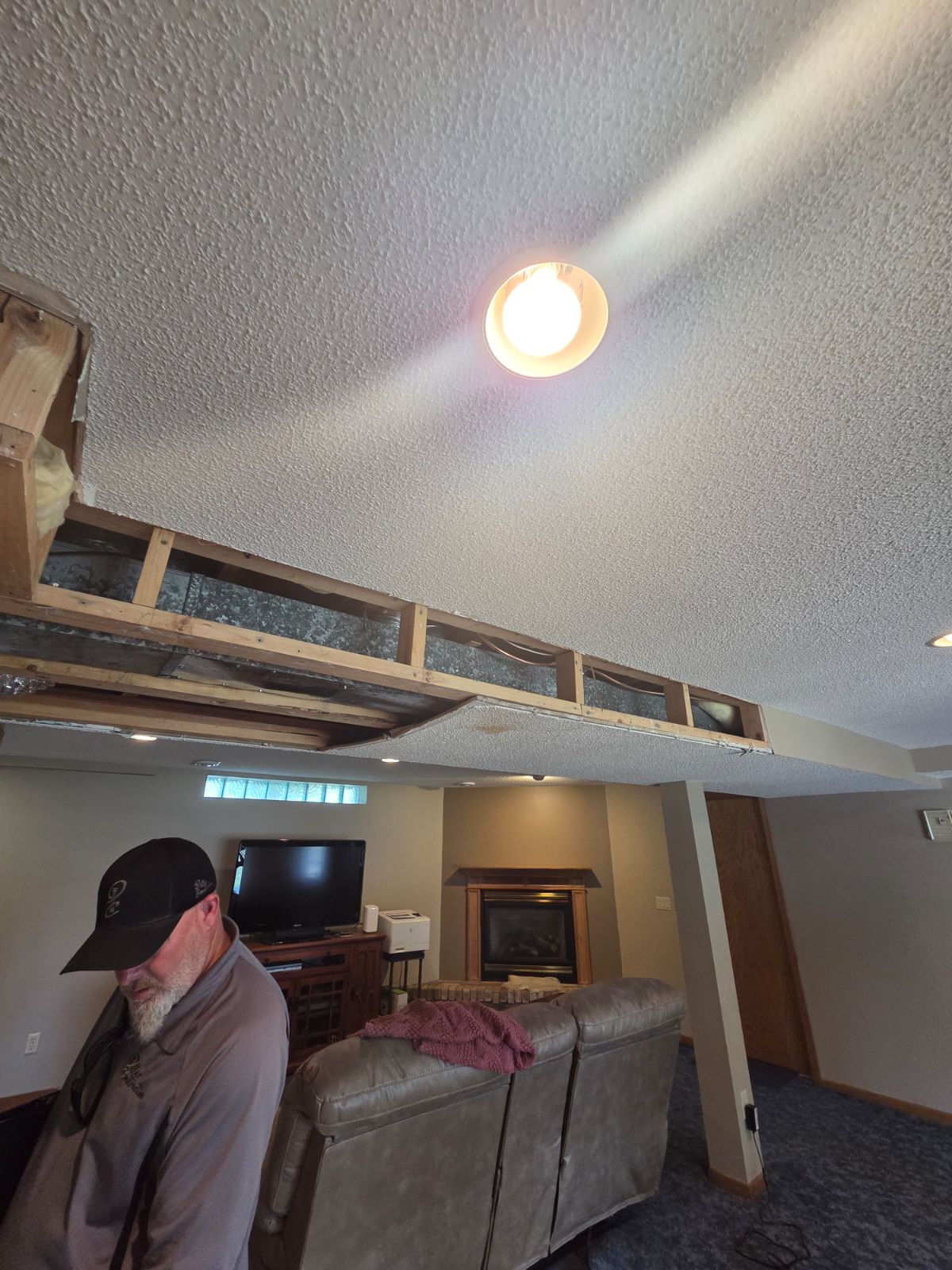 Opened ceiling soffit exposing framing and ductwork that needs repair before painting