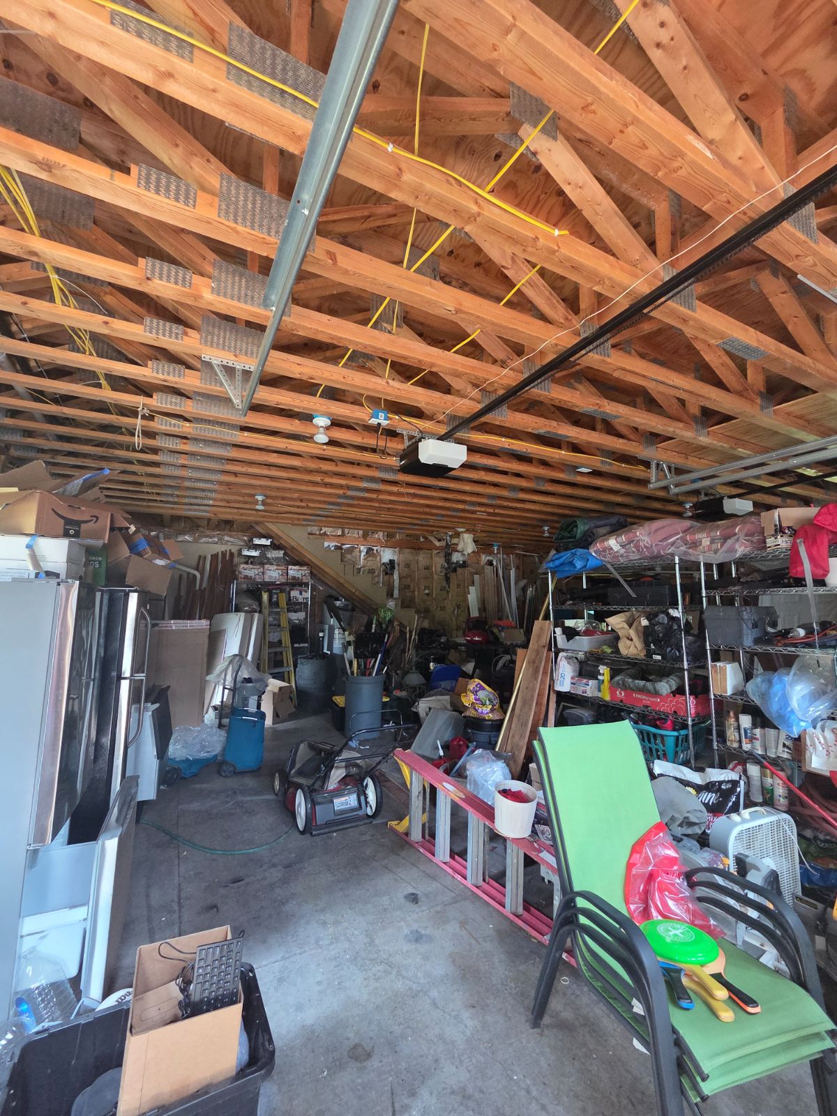 Unfinished space with exposed trusses and stored equipment, assessed during a walkthrough